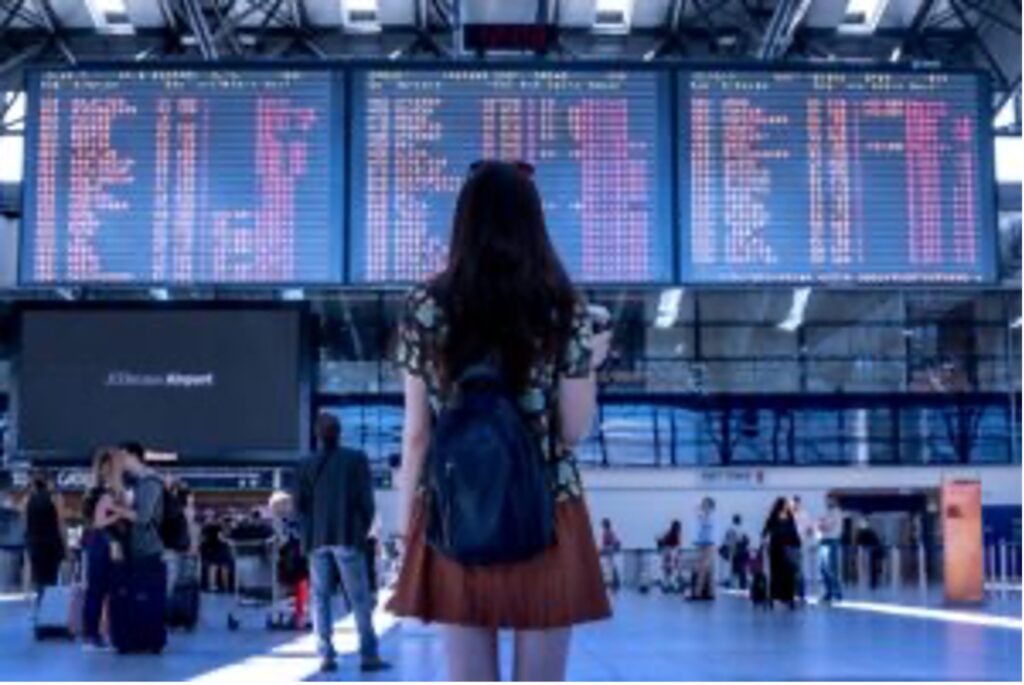 Lady looking at billboard on the airport